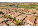Scenic aerial view of community with golf course, serene pond, and picturesque homes at 41105 N Prestancia Way, Anthem, AZ 85086