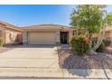 Charming single-story home with a well-manicured front yard and a two-car garage in a tranquil neighborhood at 41105 N Prestancia Way, Anthem, AZ 85086