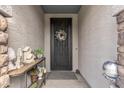 Inviting entryway with decorative door and stylish console table and décor at 5831 N 196Th Ln, Litchfield Park, AZ 85340