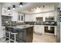 Modern kitchen features stainless steel appliances, white cabinetry, and a stylish backsplash at 6326 N 86Th N St, Scottsdale, AZ 85250