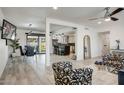 Open-concept living area with a kitchen, modern furniture, and wood-look flooring at 6326 N 86Th N St, Scottsdale, AZ 85250