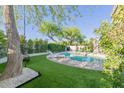 Backyard features an inviting pool with a lounge area and lush landscaping at 7278 E Echo Ln, Scottsdale, AZ 85258
