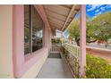 Charming covered front porch with white picket fence and colorful plants at 7302 W Cheryl Dr, Peoria, AZ 85345