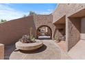 Stunning community courtyard featuring unique architectural details, lush desert landscaping, and inviting walkways at 7312 N Via Camello Del Norte St # 95, Scottsdale, AZ 85258