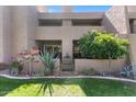 Well-maintained exterior featuring mature trees, lush lawn, and vibrant landscaping for a charming curb appeal at 7312 N Via Camello Del Norte St # 95, Scottsdale, AZ 85258