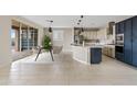 Open-concept kitchen with large island, modern appliances, and dining area with access to the backyard at 9743 E Torino Ave, Mesa, AZ 85212
