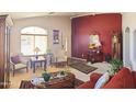 Cozy living room with ample natural light, decorative furnishings, and an elegant mirror at 10928 W Kaler Dr, Glendale, AZ 85307