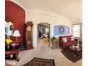 Spacious living room features neutral carpet, accent walls, and an archway leading to the next room at 10928 W Kaler Dr, Glendale, AZ 85307