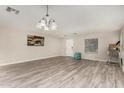 Spacious living room with light wood floors, abundant natural light, and a welcoming entryway at 11202 W Mckinley St, Avondale, AZ 85323