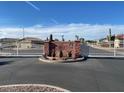 Gated community entrance with desert landscaping and cacti at 1306 N Lantana N Pl, Casa Grande, AZ 85122