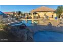 Community pool and hot tub with lounge chairs and shaded areas at 1306 N Lantana N Pl, Casa Grande, AZ 85122