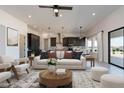 Open concept living room with stylish furniture and a view into the modern kitchen at 13914 E Barwick Dr, Scottsdale, AZ 85262