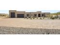 Paver driveway leads to a contemporary home with a desert landscape and gray garage doors at 14328 E Peak View Rd, Scottsdale, AZ 85262