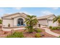 Beautiful house featuring low-maintenance landscaping, a walkway, and mature trees at 15816 W Amelia Dr, Goodyear, AZ 85395