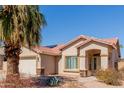 Beautiful single-Gathering home with a tiled roof and a well-manicured desert landscape at 16526 W Desert Ln, Surprise, AZ 85388