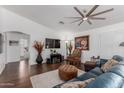 Spacious living room with hardwood floors, recessed lighting, and a stylish ceiling fan at 16526 W Desert Ln, Surprise, AZ 85388