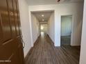 Inviting entryway with wood-look tile flooring leading into the home at 17547 W Lupine Ave, Goodyear, AZ 85338