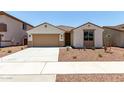 Charming single-story home featuring desert landscaping, a two-car garage, and a covered entryway at 17547 W Lupine Ave, Goodyear, AZ 85338