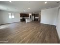 Open-concept living room with lots of natural light, tile floors, and kitchen view at 17547 W Lupine Ave, Goodyear, AZ 85338