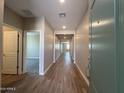 Inviting hallway with wood-look flooring and recessed lighting at 17553 W Lupine Ave, Goodyear, AZ 85338