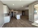 Modern kitchen featuring white cabinets, a central island, and stainless steel appliances at 17553 W Lupine Ave, Goodyear, AZ 85338