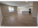 Open-concept living room and kitchen area with abundant natural light and stylish flooring at 17553 W Lupine Ave, Goodyear, AZ 85338