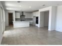 Open-concept kitchen flows into the living area, enhancing the home's modern feel at 18035 W Vogel Ave, Goodyear, AZ 85338