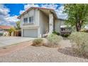 House featuring an attached garage and a red-tiled roof with xeriscaping at 1929 E Redfield Rd, Phoenix, AZ 85022