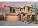 Charming two-story home featuring desert landscaping, stone accents, arched entryway, and a two car garage at 21784 E Puesta Del Sol --, Queen Creek, AZ 85142