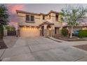 Charming two-story home featuring desert landscaping, stone accents, arched entryway, and a two car garage at 21784 E Puesta Del Sol --, Queen Creek, AZ 85142