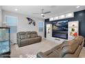 Bright and modern living room with cozy leather seating and an entertainment center with fireplace and custom shelving at 2601 S Entwistle St, Gilbert, AZ 85295