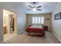 Cozy bedroom with a comfortable bed, neutral tones, and a ceiling fan at 30718 N Coral Bean Dr, San Tan Valley, AZ 85143