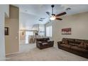 Inviting living room with plush sofas, neutral carpet, and a ceiling fan at 30718 N Coral Bean Dr, San Tan Valley, AZ 85143