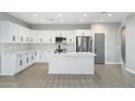 Modern kitchen featuring white cabinets, stainless steel appliances, and quartz countertops at 410 S 98Th Pl, Mesa, AZ 85208