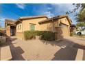 Side view of the house showing the paver driveway and the two-car garage at 412 W Lyle Ave, San Tan Valley, AZ 85140