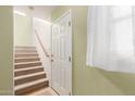 Bright entryway with carpeted stairs, neutral wall color, and natural light from a window at 453 N Alder Ct, Gilbert, AZ 85233