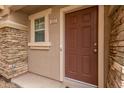 View of the front door featuring a chocolate brown door, sidelight window, and unit number at 453 N Alder Ct, Gilbert, AZ 85233