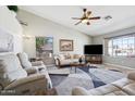 Comfortable living room with a ceiling fan, large windows, plush seating, and decorative area rug at 4846 S Rimrock Loop, Gold Canyon, AZ 85118