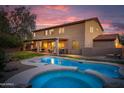 A spacious backyard featuring a pristine pool and spa with the warm glow of a sunset creating an inviting outdoor oasis at 4958 E Desert Vista Trl, Cave Creek, AZ 85331