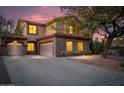 Beautiful home featuring a well-kept front yard, a three-car garage, and elegant stone details enhancing the home's curb appeal at 4958 E Desert Vista Trl, Cave Creek, AZ 85331