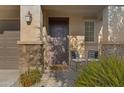 Inviting front porch with stone accents and space for seating, creating a warm entry at 5431 S Canyon Rim --, Mesa, AZ 85212