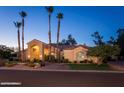 Elegant single-story home with a stucco exterior, mature palm trees, and a beautifully landscaped front yard at 6132 E Yucca St, Scottsdale, AZ 85254