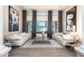 Bright living room featuring hardwood floors, modern art, large windows and two sofas facing each other at 6132 E Yucca St, Scottsdale, AZ 85254