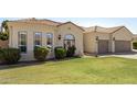 Charming single-story home with a well-manicured lawn, three-car garage, and a lovely tile roof at 6343 E Odessa St, Mesa, AZ 85215