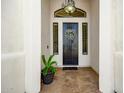 Inviting front door featuring an ornamental wreath and decorative sidelights for a warm, welcoming entrance at 6343 E Odessa St, Mesa, AZ 85215