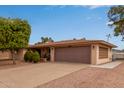 Single story home featuring an attached two car garage and well-maintained landscaping at 641 N 61St Pl, Mesa, AZ 85205