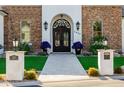 Elegant front entrance featuring a paved walkway, stone pillars, and a decorative wrought-iron door at 7482 S Mccormick Way, Queen Creek, AZ 85142