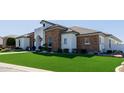 Charming front exterior with lush green lawn and well-manicured landscaping at 7482 S Mccormick Way, Queen Creek, AZ 85142