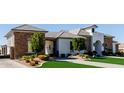 Beautiful home featuring stone and stucco facade, well-maintained landscaping, and driveway at 7482 S Mccormick Way, Queen Creek, AZ 85142