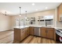 Bright kitchen features stainless steel appliances, pendant lights, and quartz countertops at 8377 E Indian School Rd, Scottsdale, AZ 85251